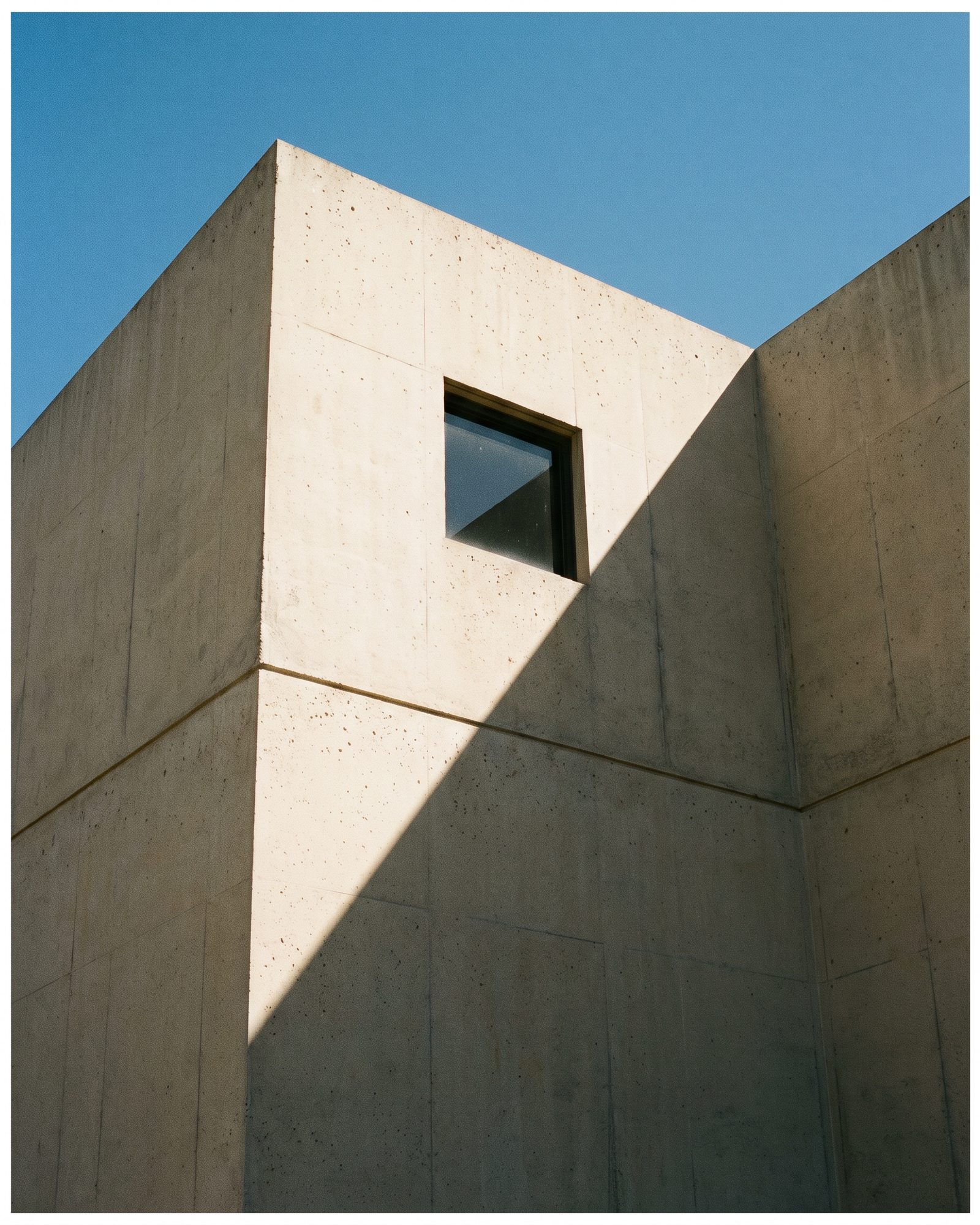The corner of a concrete building against sky