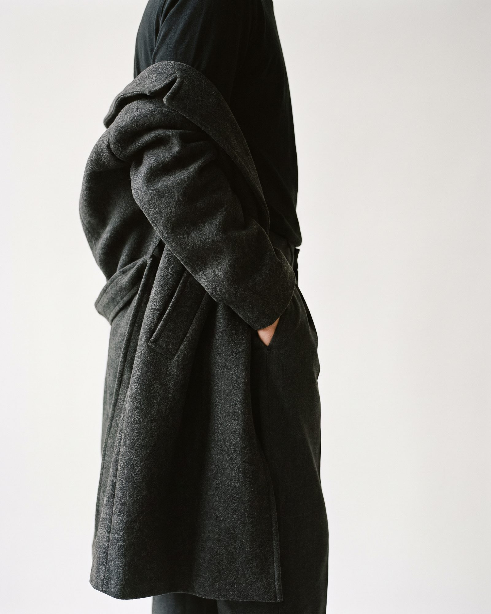 The drape of a charcoal wool coat