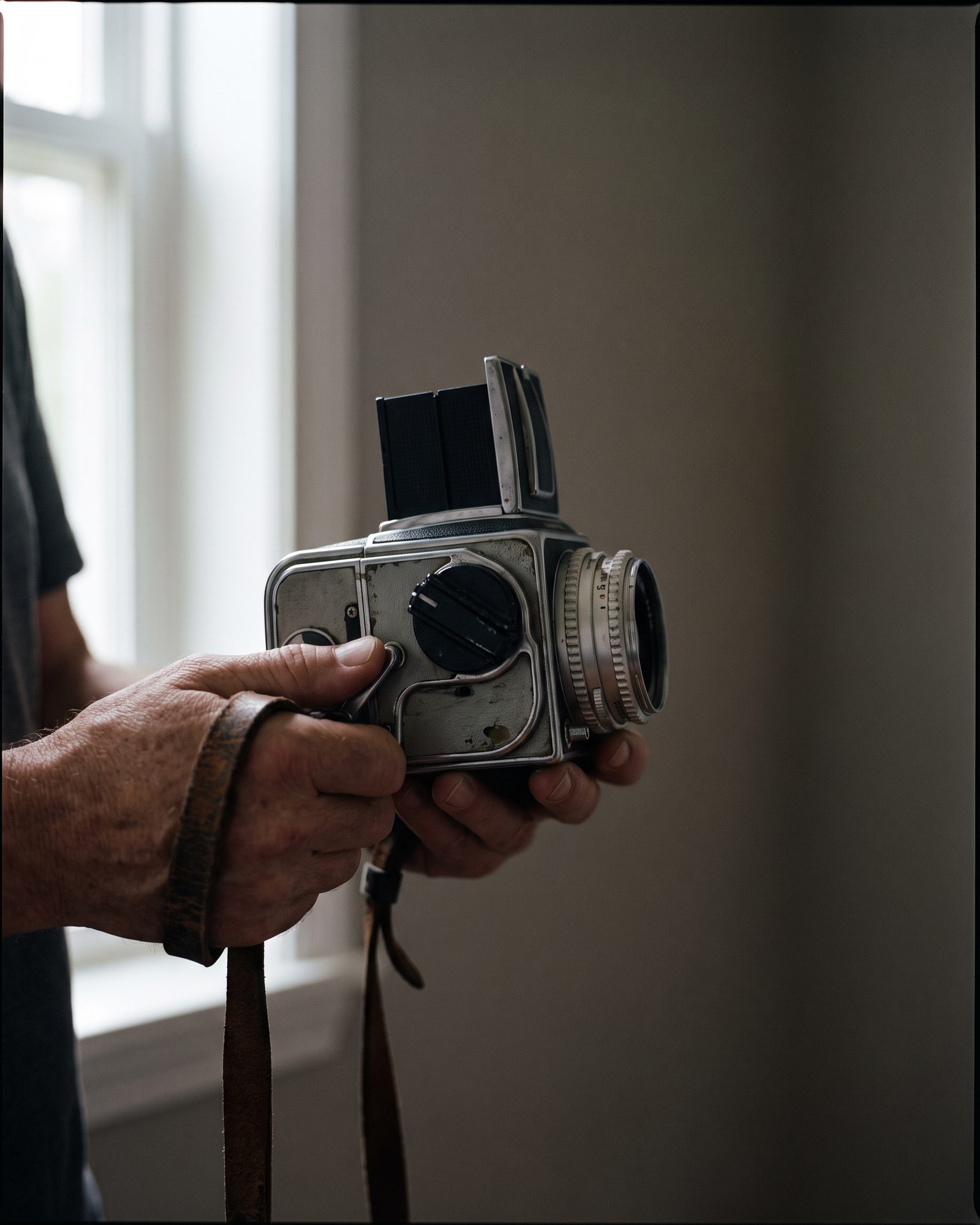 Hands holding a medium-format camera